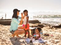 family on beach protecting themselves from the sun